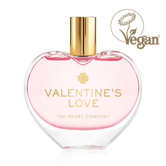 Valentine’s Love vegan eau de parfum by The Heart Company in a clear glass, elegant heart-shaped bottle with a golden cap, cruelty-free fragrance with a soft pink hue for romantic gifting