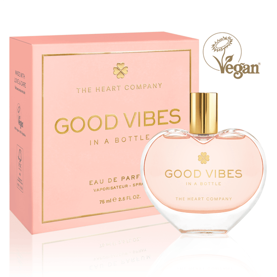 Vegan eau de parfum in a heart-shaped glass bottle with gold cap, “Good Vibes in a Bottle,” featuring a fruity, floral, sweet gourmand fragrance, beautifully packaged in soft pink for a feel-good, cruelty-free luxury perfume experience