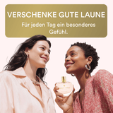 Two women holding a perfume bottle with a text overlay in German.
