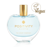 Positivity in a Bottle vegan perfume by The Heart Company in a clear heart-shaped glass bottle with gold cap, featuring a fresh, aquatic, clean fragrance that feels light, uplifting, and energizing for everyday wellness