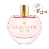 Valentine’s Love vegan eau de parfum by The Heart Company in a clear glass, elegant heart-shaped bottle with a golden cap, cruelty-free fragrance with a soft pink hue for romantic gifting