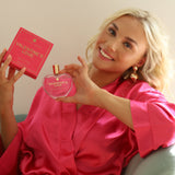 Lifestyle image of Valentine’s Love vegan eau de parfum by The Heart Company, showing a person holding the heart-shaped bottle and pink gift box, presented as a romantic, cruelty-free fragrance for Valentine’s Day gifting