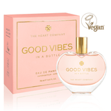 Vegan eau de parfum in a heart-shaped glass bottle with gold cap, “Good Vibes in a Bottle,” featuring a fruity, floral, sweet gourmand fragrance, beautifully packaged in soft pink for a feel-good, cruelty-free luxury perfume experience