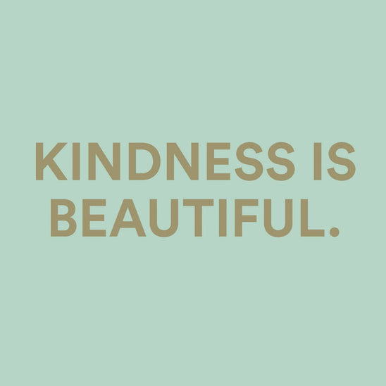 Motivational quote “Kindness Is Beautiful” displayed in gold typography on a soft mint green background, reflecting the Kindness in a Bottle message by The Heart Company and conveying elegance, positivity, and mindful self-care values